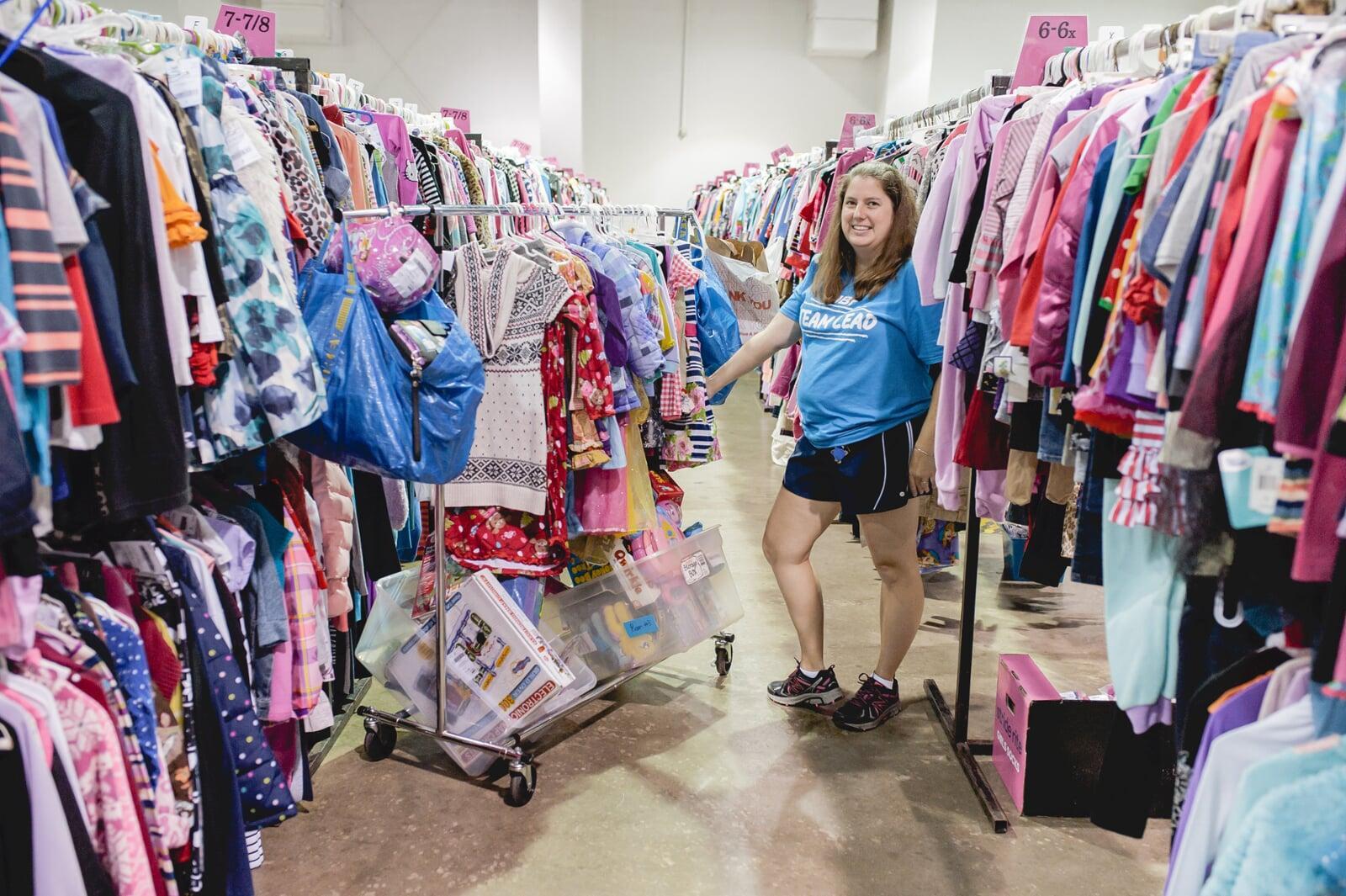 A cashier smiles behind her mask as she gets ready to check out the next happy JBF customer.