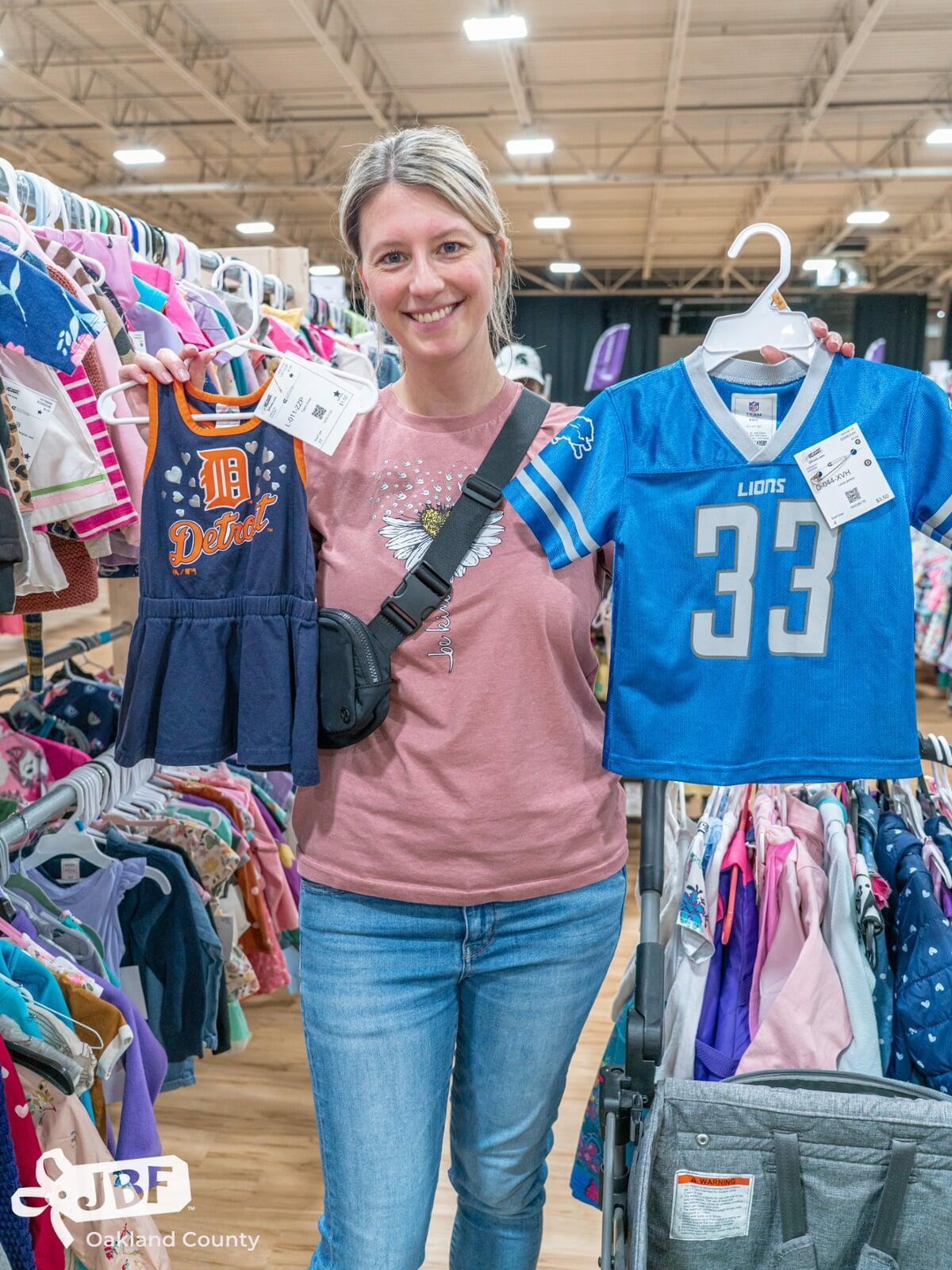 A mom, abuela and granddaughter attend a JBF sale in Dallas. Abuela is holding a babyseat.